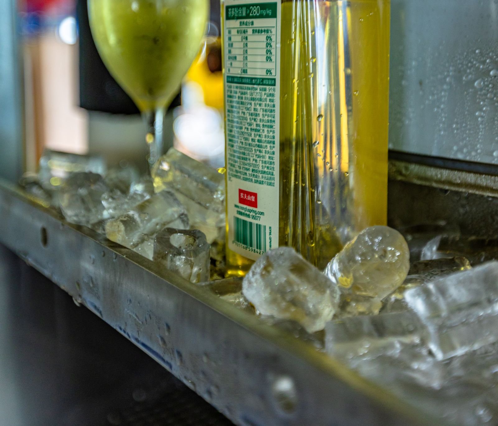 Clear ice chilling a drink on a bar rail
