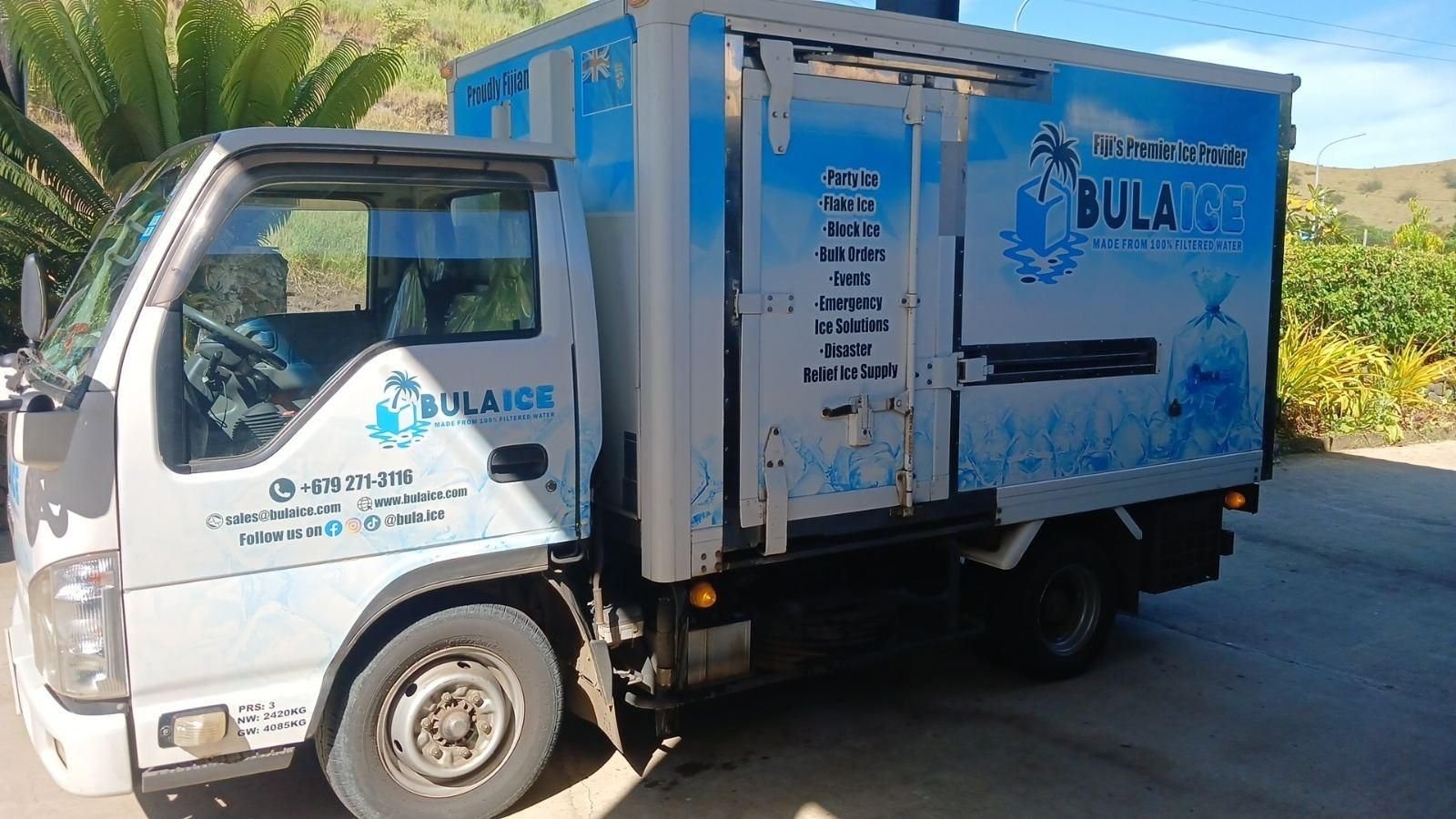 The Bula Ice freezer truck parked beside palms
